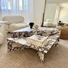 a living room filled with furniture and a large mirror