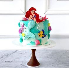 the little mermaid cake is decorated with fondant