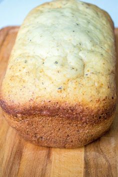 a loaf of bread sitting on top of a wooden cutting board