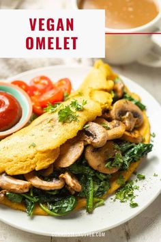 vegan omelet with mushrooms, spinach and tomatoes on a white plate