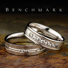 two wedding rings sitting on top of each other with the words be n chmark above them