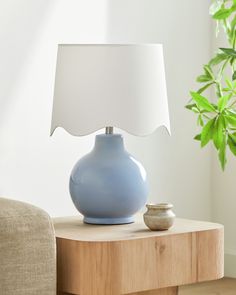 a blue lamp sitting on top of a wooden table