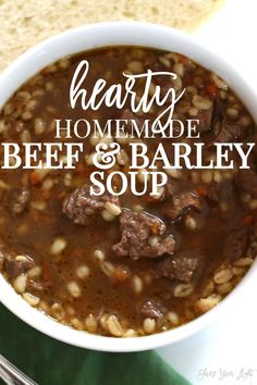 hearty homemade beef and barley soup in a white bowl with bread on the side