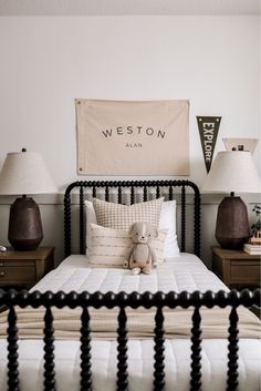 a teddy bear sitting on top of a bed in a room with two nightstands