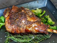 a piece of meat and some broccoli on a pan