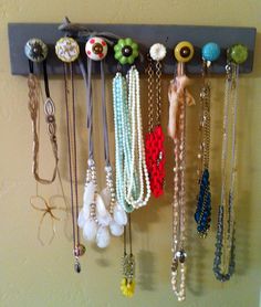 there are many necklaces hanging on the wall