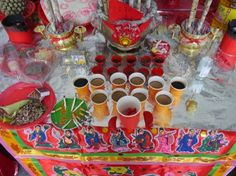 a table topped with lots of cups and plates