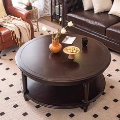 a living room with two couches and a coffee table in the middle of it