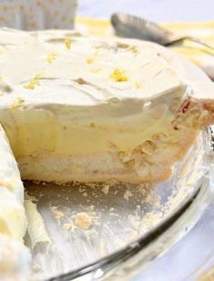 a piece of lemon pie on a plate with a slice taken out of it's crust