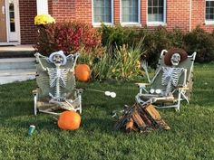 two lawn chairs decorated with skeletons and pumpkins