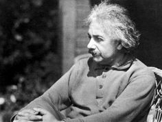 an old black and white photo of a man sitting in a chair looking off to the side