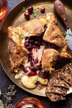 a plate topped with bread and cranberry sauce next to crackers on a table