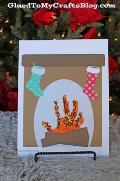 a handmade christmas card with an image of a potted plant and stockings on it