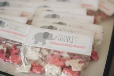 there are many small bags of treats on the table together, including one with an elephant sticker