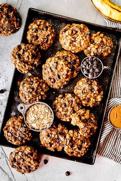 an overhead view of cookies and bowls of oatmeal on a baking tray