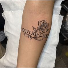 a woman with a rose tattoo on her arm that says xxvi - xixm