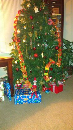 a christmas tree with presents under it