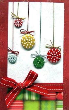 a handmade christmas card with ornaments hanging from the front and back of it,