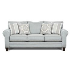 a light blue couch with two pillows on the back and one pillow that is in front of it