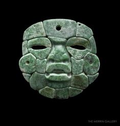 an ancient mask is shown against a black background