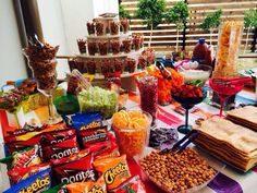 a table filled with snacks and desserts on top of it