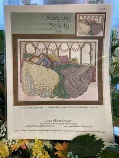 a cross stitch pattern for sleeping beauty with flowers in the foreground and an image of a woman laying on her bed