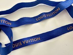 two blue lanyards with the words louis vuitton on them