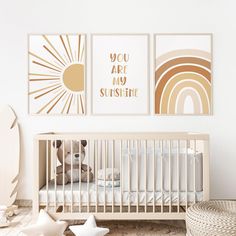 a baby's room with two pictures on the wall and a crib in the foreground