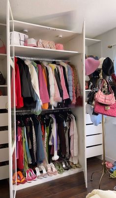 a closet filled with lots of clothes and handbags