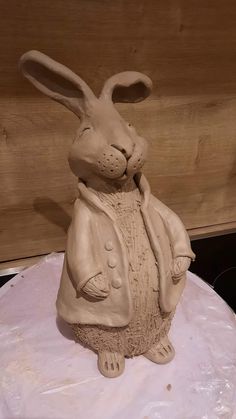 a clay rabbit sitting on top of a cake