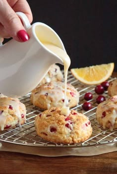 orange cranberry scones with icing being drizzled