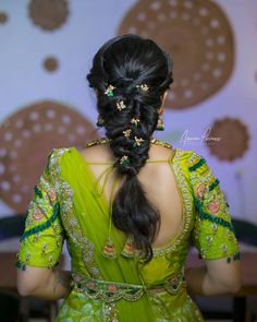 a woman with long hair in a green sari