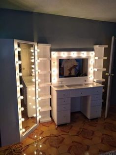 a white vanity with lights on it in a room