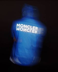 a man wearing a blue jacket with the word moncler wonceb on it