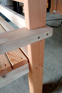 a wooden bench sitting on top of a hard wood floor