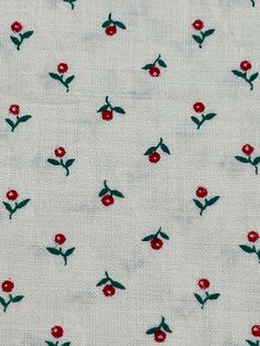 white fabric with red flowers and green leaves