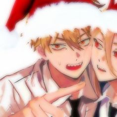 two people wearing santa hats and pointing at something with their fingers in front of them