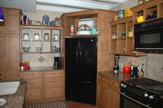 a black refrigerator freezer sitting inside of a kitchen