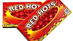 two boxes of red hots candy sitting next to each other on a white background