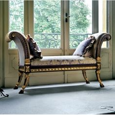 an ornately decorated bench in front of a window