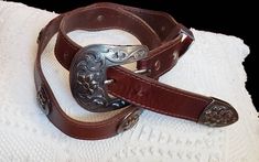 Women's western waist belt Color brown  Engraved buckle  1995 Length 38 inches  First hole at 28, 29,30, 31,32 inches  See measurements on photo please  Great vintage condition Western Brown Belts And Suspenders With Antique Buckle, Western Concho Belts For Ranch, Western Antique Belt Buckles For Festival, Southwestern Style Adjustable Belt With Antique Buckle, Southwestern Adjustable Belts With Antique Buckle, Southwestern Adjustable Belt With Antique Buckle, Western Style Brown Antique Belt Buckle, Western Brown Antique Buckle Belt, Western Style Brown Belt Buckle With Antique Buckle