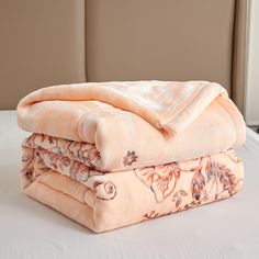 two blankets are stacked on top of each other