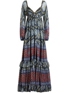 a women's dress with long sleeves and an intricate print on the front, in blue