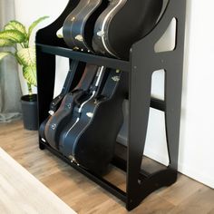 guitar cases are stacked up on a shelf