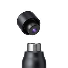 a black bottle with a camera attached to it's top and the lid open