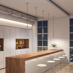 an empty bar with four stools in front of it and a view of the city