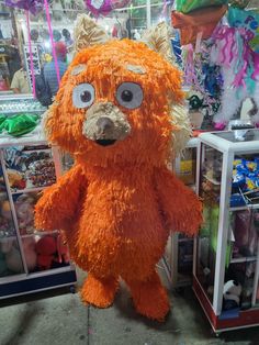 a large orange stuffed animal with big eyes