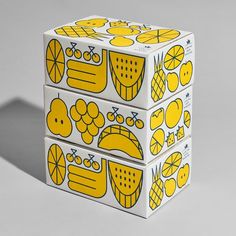 two boxes with yellow and white designs on them