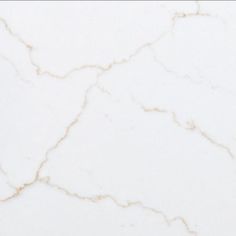 a white marble counter top with cracks in the middle and gold veining on it