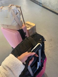 a woman is holding her luggage at the airport